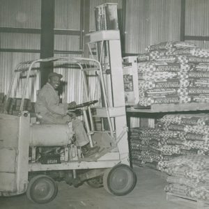 Jefferson Feed Employee moving bags of animal feed on forklift